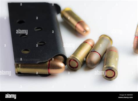 Close up of 22mm caliber bullets in a black gun clip isolated on white ...