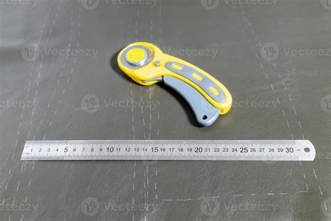 steel ruler and rotary cutter on leather 11185535 Stock Photo at Vecteezy