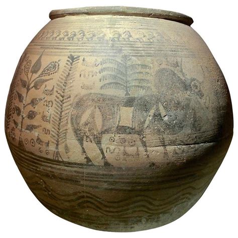 an old vase with some pictures on it