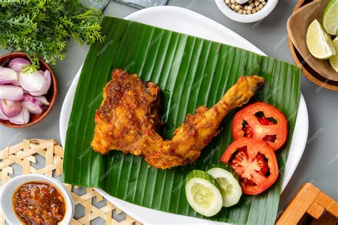 Premium Photo | Ayam bakar or roasted chicken on banana leaf ayam bakar ...