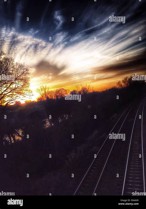 Train track sunset Stock Photo - Alamy