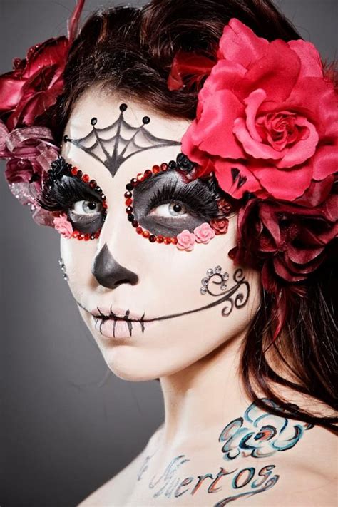 Beautiful Dia de los Muertos make-up accompanied by large pink rose ...