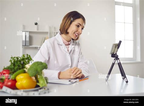 Nutritionist at the clinic video calling patient for online ...