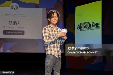 Japanese comic book author Hajime Isayama poses after being awarded ...