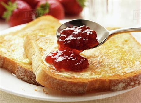 Toast with butter and strawberry jam - Stock Photo - Dissolve