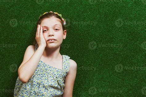 Little girl is lying on artificial grass 23924706 Stock Photo at Vecteezy