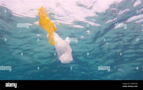 Plastic bag in blue ocean water. Plastic pollution in ocean ...