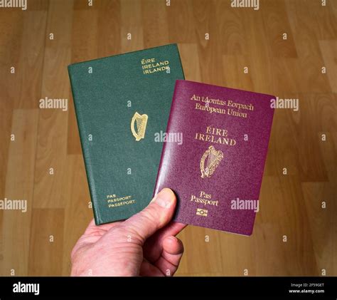 Up to date red color Irish passport (European Union) alongside an old ...