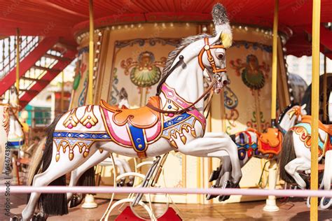 Horses on a carnival Merry Go Round. Old French carousel in a holiday ...