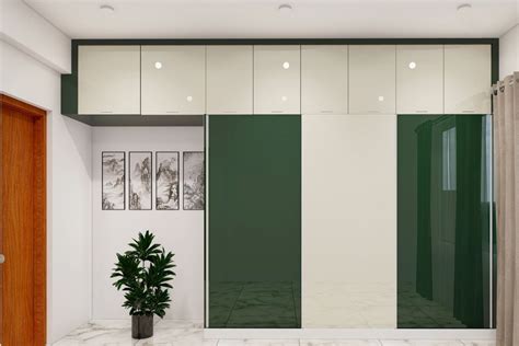 Green and White Sliding Door Modern Wardrobe Design with Loft | Livspace