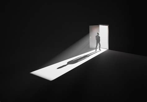 Premium Photo | Man walking out of a dark room through opened door