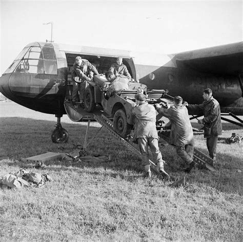 A jeep is loaded aboard a Horsa glider during a large-scale airborne ...