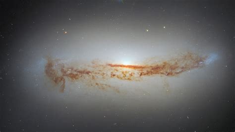 New Hubble photo shows galaxy's bright supermassive black hole cloaked ...