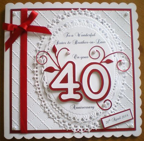 an anniversary card with the number forty on it and a red ribbon tied ...