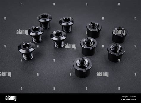 Black Steel Nuts bolts at black background Stock Photo - Alamy