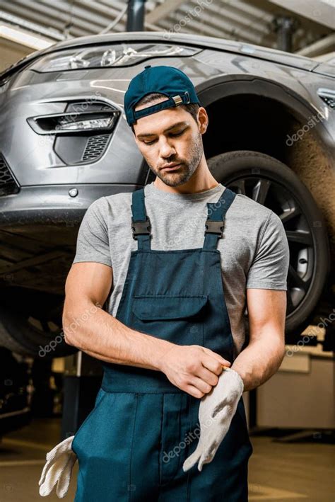 auto repair Portrait Auto Mechanic Uniform Wearing Protective Gloves ...