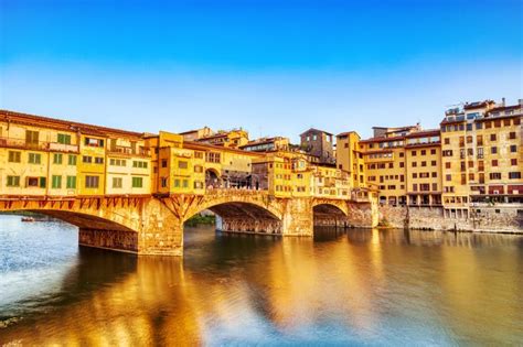 Golden Sunset Over Ponte Vecchio Bridge with Reflection in Arno River ...