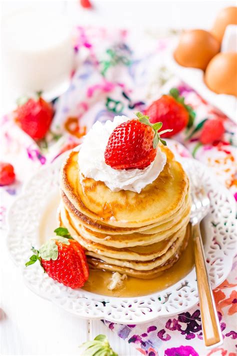 Stack of Cream Cheese Pancakes on whiter plate with whipped cream ...