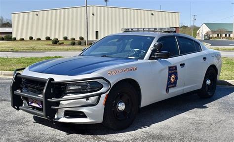 a police car parked in front of a building