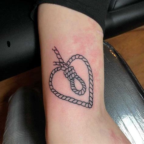 Heart-shaped rope with a hangman’s knot inside tattooed on the arm ...