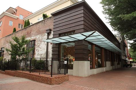 contemporary storefront--love the idea of a canopy wrapping the corner ...