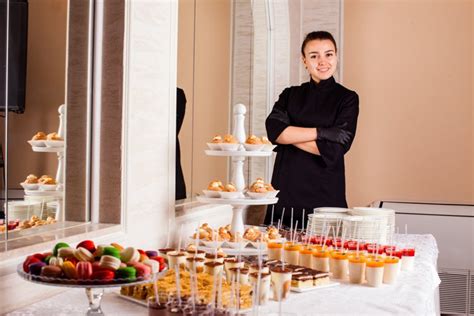 Pastry chef standing near dessert table