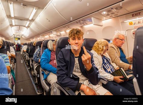 A cheeky teenage boy on a Boeing 737 in flight on a TUI plane Stock ...