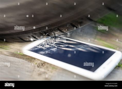 Phone run over by car Stock Photo - Alamy