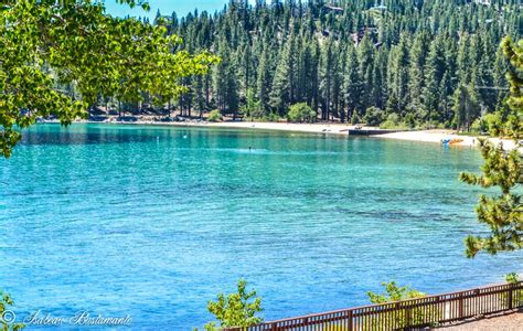 the water is crystal blue and there are trees around it