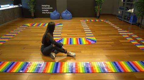 a woman sitting on the floor in front of an array of colored squares ...