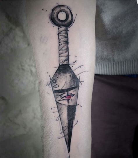 a man's arm with a tattoo on it that has a knife and a key attached to it