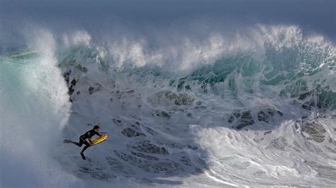 Photos of the Week: Surfing Hurricane Waves, and More