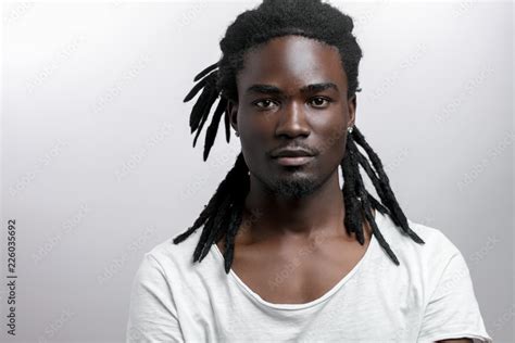 African American male with dreadlocks on white background looking at ...