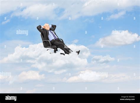 Mature businessman resting in armchair and floating on a cloud Stock ...