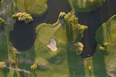 Aerial view of a green golf course at sunset 27090430 Stock Photo at ...