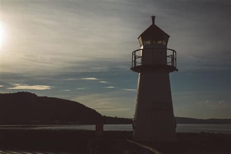 Lighthouse in silhouette at sunset and dramatic sky. Place for text or ...