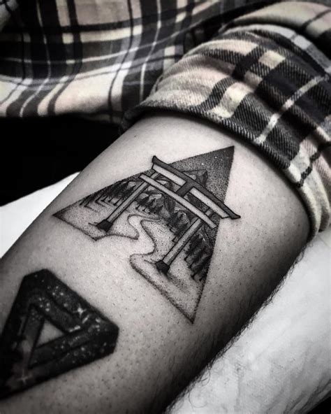 a black and white photo of a person's arm with a tattoo on it