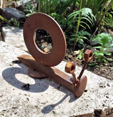 a metal object sitting on top of a rock