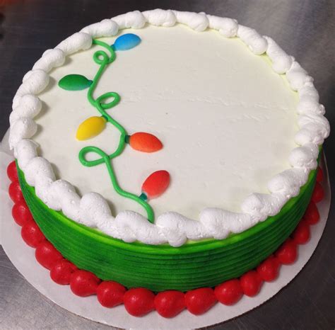 a cake with white frosting and green icing decorated with colorful ...