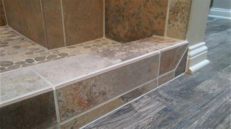 how to tile a shower curb (against vinyl plank ) - YouTube