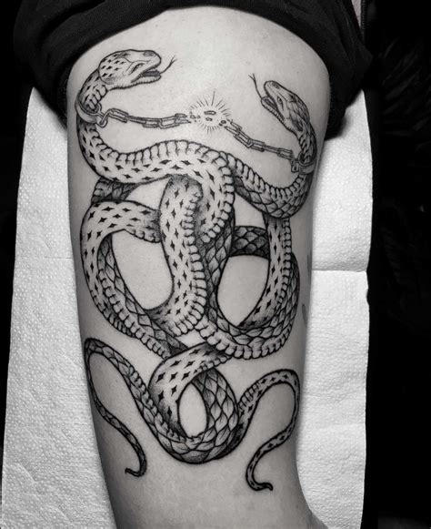 Intertwined snakes tattoo - Tattoogrid.net