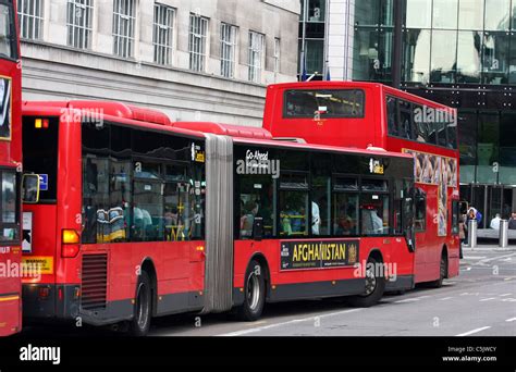 A bendy bus and a double decker bus at a bus stop in London Stock Photo ...