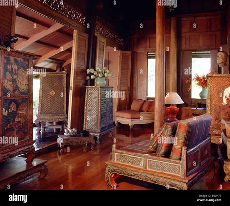 Traditional Thai house with old manuscript cabinet, table, and silk ...