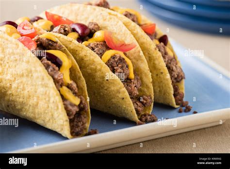 Mexican tacos with beef, cheddar cheese, tomato Stock Photo - Alamy