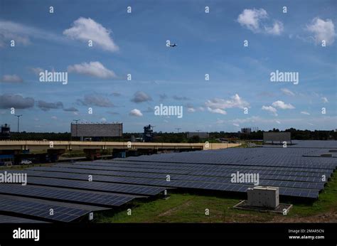 An airplane takes off over solar panels at the Cochin International ...