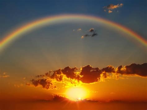 Premium Photo | Rainbow at sunset on cloudy sky at sea