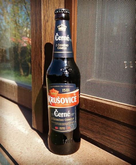 a bottle of beer sitting on top of a window sill