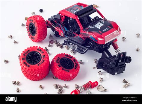 Disassembled car and scattered parts. Broken toy Stock Photo - Alamy