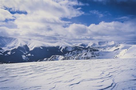 Snow Covered Hills Under White Clouds · Free Stock Photo