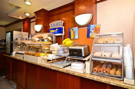 a breakfast buffet with donuts, bananas and other items on the counter ...